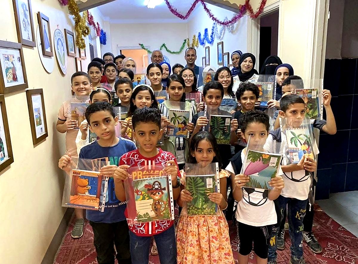 Drawing-class children with their artwork